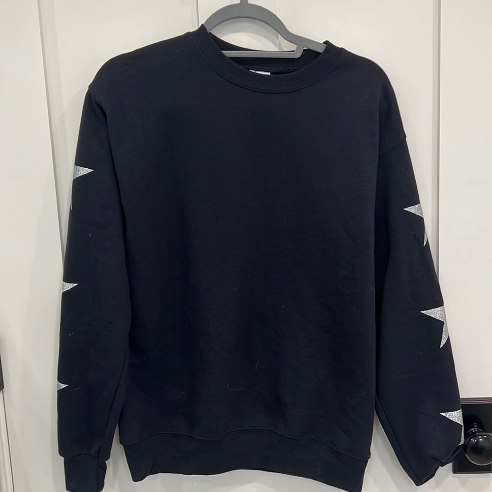 Black crewneck with silver stars on arm